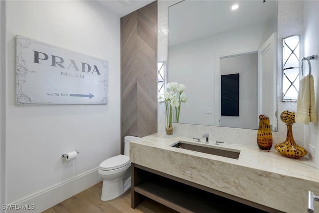 541 Whispering Pine Ct, Naples, FL 34103 - bathroom with toilet, vanity, and wood finished floors