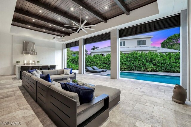 541 Whispering Pine Ct, Naples, FL 34103 - living room featuring wooden ceiling with exposed beams, stone tile flooring, a ceiling fan, and a towering ceiling