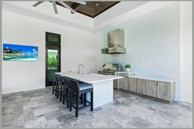 541 Whispering Pine Ct, Naples, FL 34103 - kitchen with extractor fan, a sink, wood ceiling, modern cabinets, and a center island with sink