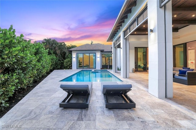 541 Whispering Pine Ct, Naples, FL 34103 - pool at dusk with a patio area and an outdoor pool