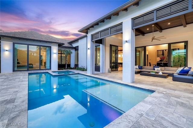 541 Whispering Pine Ct, Naples, FL 34103 - pool at dusk with outdoor lounge area, a patio, ceiling fan, and a pool with connected hot tub