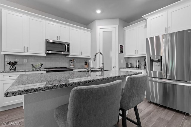 1806 SW 17th St, Cape Coral, FL 33991 - kitchen featuring appliances with stainless steel finishes, a sink, a kitchen breakfast bar, recessed lighting, and an island with sink