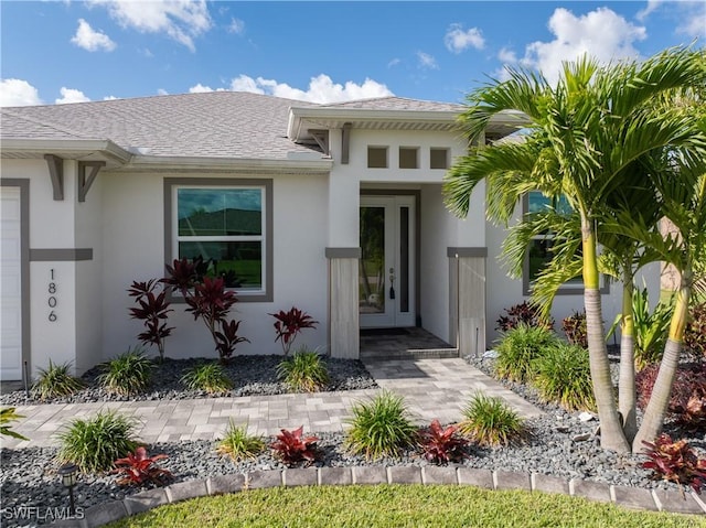 1806 SW 17th St, Cape Coral, FL 33991 - view of exterior entry with stucco siding and a shingled roof