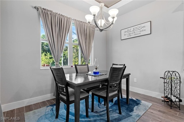 1806 SW 17th St, Cape Coral, FL 33991 - dining space featuring a chandelier, baseboards, and wood finished floors