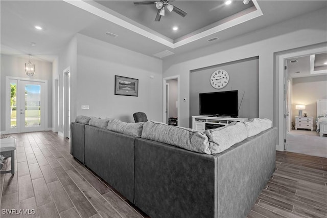 1806 SW 17th St, Cape Coral, FL 33991 - living area with wood tiled floors, a tray ceiling, a ceiling fan, recessed lighting, and a chandelier
