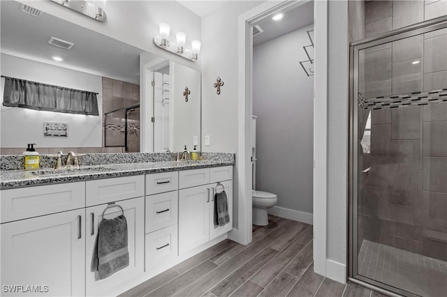 1806 SW 17th St, Cape Coral, FL 33991 - full bath with a shower stall, toilet, double vanity, wood finish floors, and baseboards
