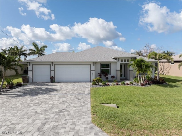 1806 SW 17th St, Cape Coral, FL 33991 - prairie-style house featuring a garage, decorative driveway, a front yard, and stucco siding