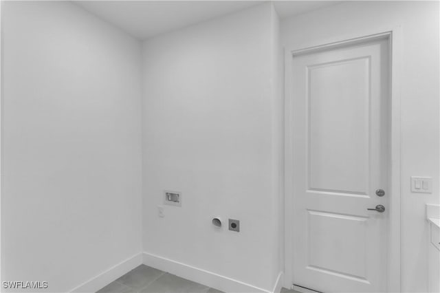 laundry area featuring electric dryer hookup, washer hookup, baseboards, and light tile patterned floors