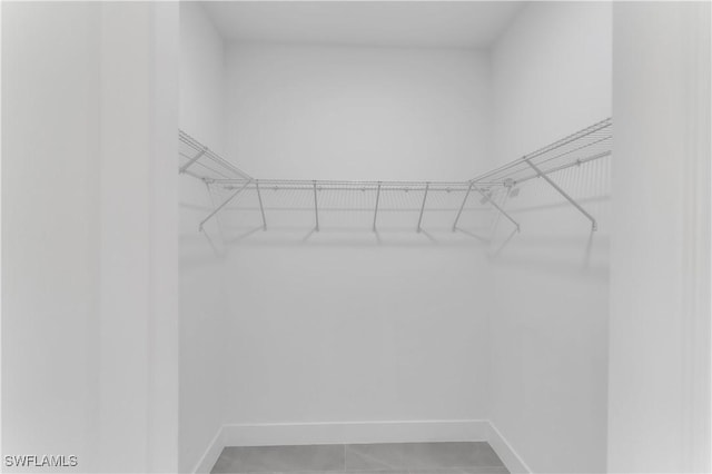 spacious closet with light tile patterned flooring
