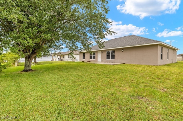 rear view of property featuring stucco siding and a patio area
