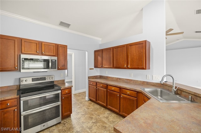 kitchen with stainless steel appliances, a sink, lofted ceiling, ceiling fan, and ornamental molding