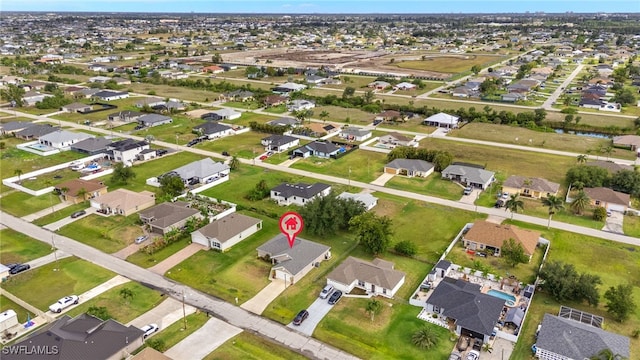 aerial view of property and surrounding area featuring nearby suburban area