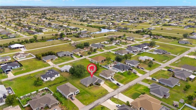 aerial view of property and surrounding area with nearby suburban area and a nearby body of water