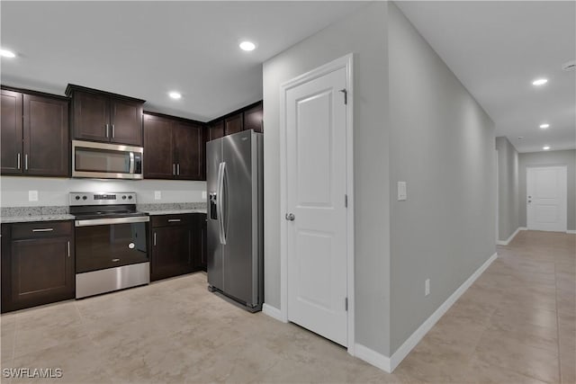 23206 Fitzpatrick Ave, Port Charlotte, FL 33980 - kitchen featuring appliances with stainless steel finishes, dark brown cabinetry, recessed lighting, light stone counters, and baseboards