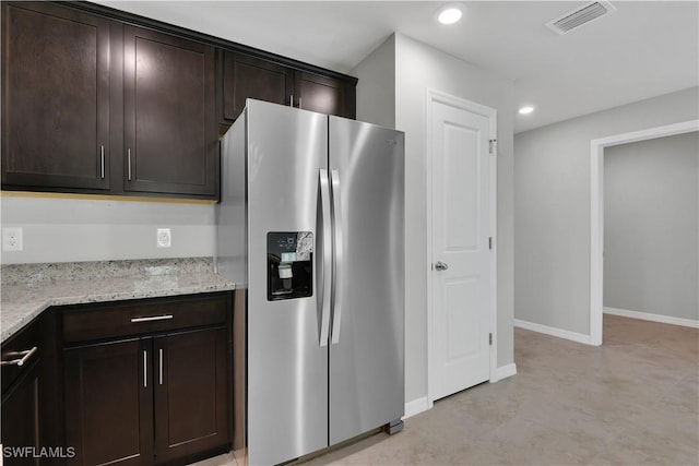 23206 Fitzpatrick Ave, Port Charlotte, FL 33980 - kitchen featuring stainless steel refrigerator with ice dispenser, dark brown cabinets, light stone countertops, recessed lighting, and baseboards