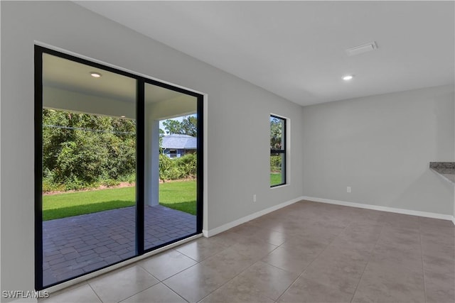 23206 Fitzpatrick Ave, Port Charlotte, FL 33980 - tiled spare room featuring baseboards and recessed lighting