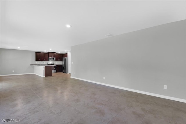 23206 Fitzpatrick Ave, Port Charlotte, FL 33980 - unfurnished living room with recessed lighting and baseboards