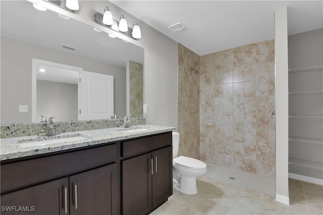 23206 Fitzpatrick Ave, Port Charlotte, FL 33980 - full bathroom with double vanity, a tile shower, toilet, and tile patterned floors