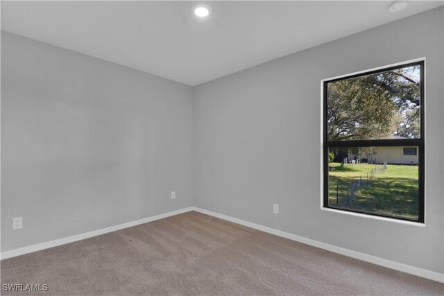 23206 Fitzpatrick Ave, Port Charlotte, FL 33980 - carpeted empty room with baseboards and recessed lighting