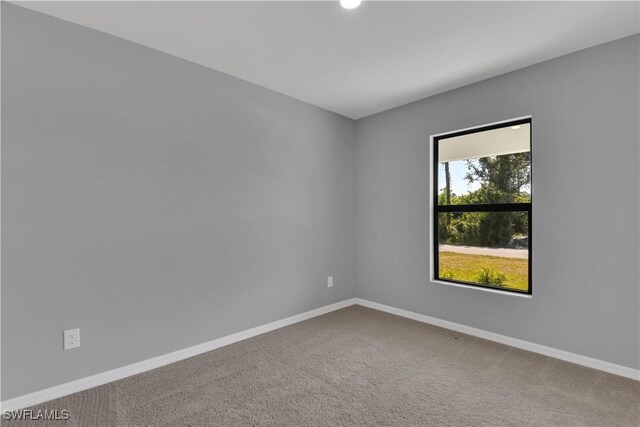 23206 Fitzpatrick Ave, Port Charlotte, FL 33980 - carpeted empty room with baseboards and recessed lighting