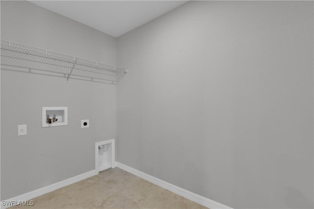 23206 Fitzpatrick Ave, Port Charlotte, FL 33980 - clothes washing area featuring hookup for an electric dryer, hookup for a washing machine, and baseboards
