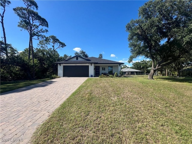 23206 Fitzpatrick Ave, Port Charlotte, FL 33980 - single story home with an attached garage, decorative driveway, a front yard, and stucco siding