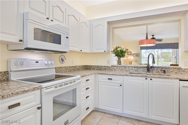 14971 Vista View Way Unit 1003, Fort Myers, FL 33919 - kitchen featuring white appliances, a sink, white cabinetry, and light stone countertops