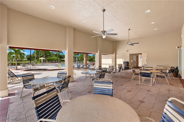 14971 Vista View Way Unit 1003, Fort Myers, FL 33919 - view of patio / terrace featuring outdoor dining area, fence, ceiling fan, and a community pool