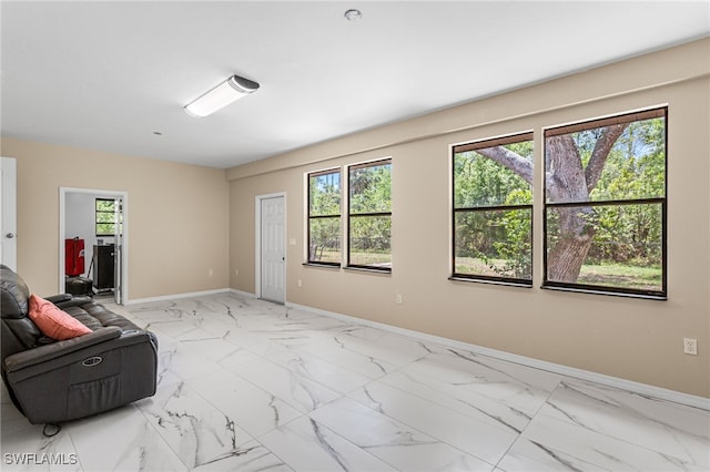 16351 Karen Way N, Fort Myers, FL 33917 - unfurnished living room with baseboards and light marble finish floors