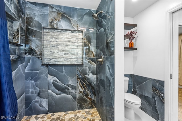 16351 Karen Way N, Fort Myers, FL 33917 - bathroom featuring tile walls, walk in shower, toilet, and wainscoting
