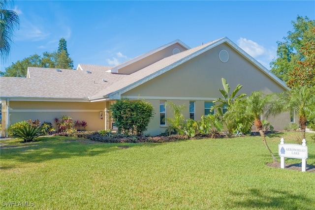 20010 Wolfel Trl, Estero, FL 33928 - view of front of home with a front lawn, stucco siding, and roof with shingles