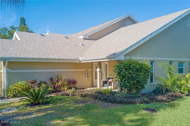 20010 Wolfel Trl, Estero, FL 33928 - view of front of house featuring a front yard, roof with shingles, and stucco siding