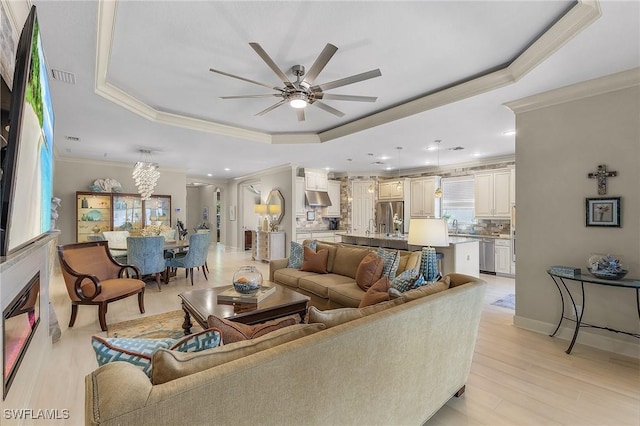 2736 Lambay Ct, Cape Coral, FL 33991 - living room with a tray ceiling, ornamental molding, ceiling fan, recessed lighting, and light wood finished floors