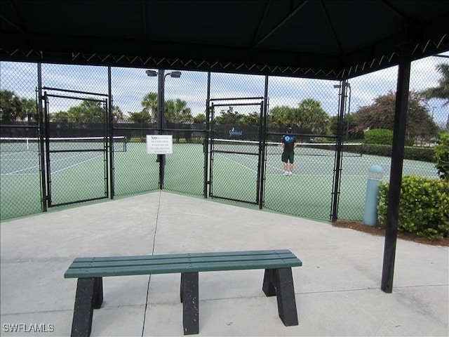 2736 Lambay Ct, Cape Coral, FL 33991 - view of tennis court featuring a gate and fence