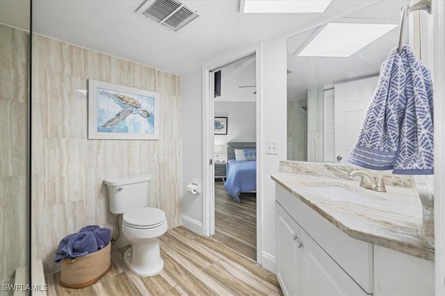 950 Moody Rd Unit 111, North Fort Myers, FL 33903 - full bathroom with toilet, wood finished floors, vanity, and connected bathroom