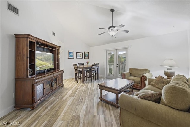 950 Moody Rd Unit 111, North Fort Myers, FL 33903 - living room featuring french doors, ceiling fan, light wood finished floors, baseboards, and high vaulted ceiling