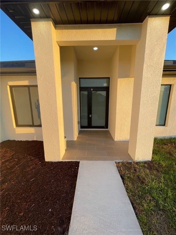 view of exterior entry with stucco siding