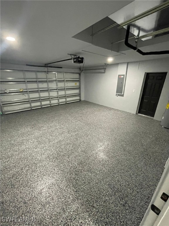 garage with a garage door opener and electric panel