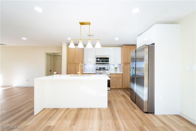 203 Carol Way, Fort Myers, FL 33905 - kitchen with stainless steel appliances, a sink, light wood-type flooring, and recessed lighting