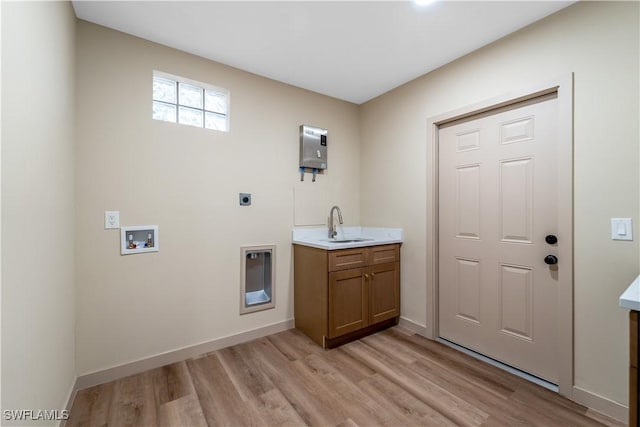 203 Carol Way, Fort Myers, FL 33905 - laundry room with hookup for an electric dryer, light wood-type flooring, cabinet space, hookup for a washing machine, and baseboards