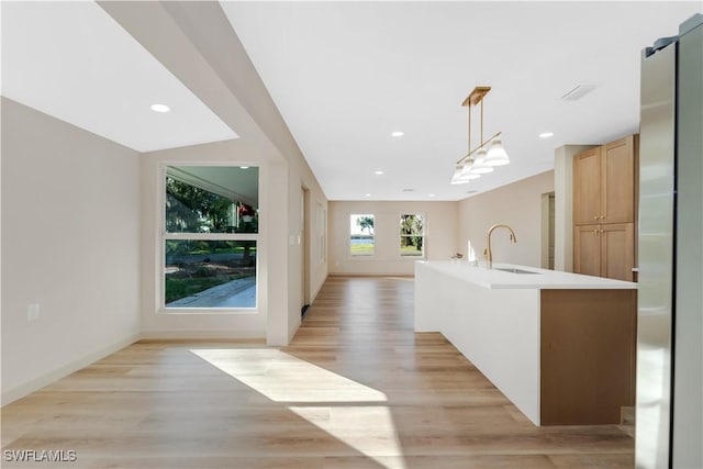 203 Carol Way, Fort Myers, FL 33905 - kitchen with a sink, open floor plan, light wood-type flooring, light countertops, and hanging light fixtures