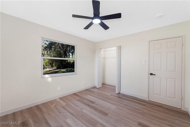 203 Carol Way, Fort Myers, FL 33905 - unfurnished bedroom with light wood-style flooring, baseboards, ceiling fan, and a closet