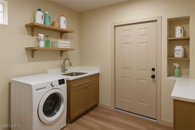 203 Carol Way, Fort Myers, FL 33905 - washroom with washer / clothes dryer, cabinet space, and light wood finished floors