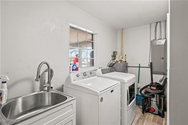12206 Boat Shell Dr, Matlacha Isles, FL 33991 - laundry room with separate washer and dryer, electric panel, and light wood-style flooring