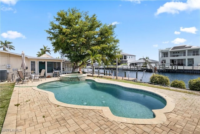 12206 Boat Shell Dr, Matlacha Isles, FL 33991 - view of swimming pool featuring a patio area, a water view, a grill, a pool with connected hot tub, and central AC unit