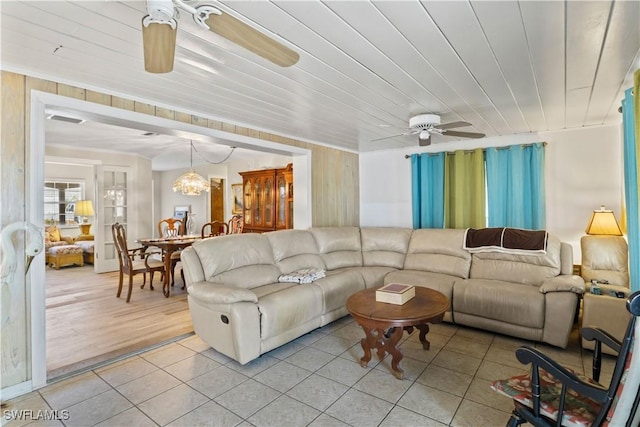 12206 Boat Shell Dr, Matlacha Isles, FL 33991 - living area featuring ceiling fan, light tile patterned flooring, wood walls, a chandelier, and wood ceiling