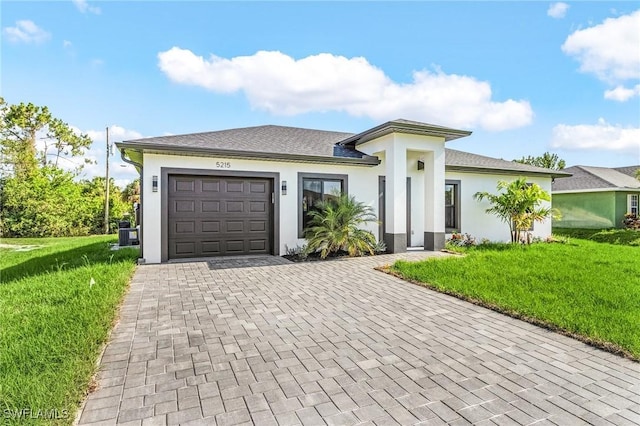 5215 7th St W, Lehigh Acres, FL 33971 - view of front of home featuring decorative driveway, a garage, a front yard, and stucco siding