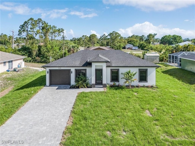 5215 7th St W, Lehigh Acres, FL 33971 - view of front of property with decorative driveway, a garage, a front lawn, and roof with shingles