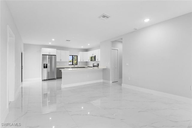 5215 7th St W, Lehigh Acres, FL 33971 - kitchen with appliances with stainless steel finishes, baseboards, light countertops, white cabinetry, and recessed lighting