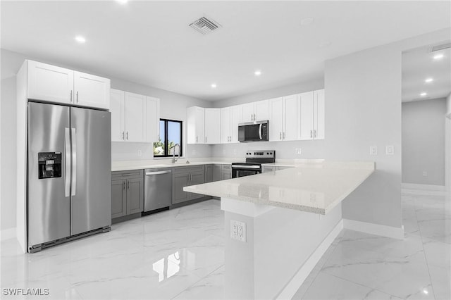 5215 7th St W, Lehigh Acres, FL 33971 - kitchen featuring appliances with stainless steel finishes, light marble finish flooring, baseboards, a peninsula, and recessed lighting